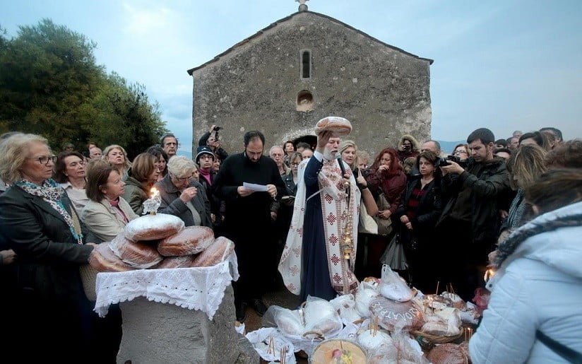 Eleusis, The Custom of the Holy Virgin of Mesosporitissa - Gastronomy Tours the Holy Virgin of Mesosporitissa church of Eleusis with a priest surrounded by people